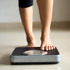 Person stepping on weight scales