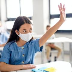 Girl with mask in classroom